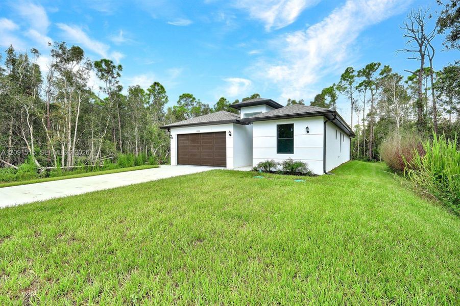 Front exterior of a new home in , Punta Gorda, FL, highlighting curb appeal (Image 19).