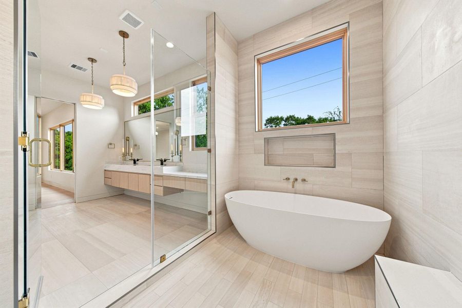 Natural limestone — floor-to-ceiling surround - Natural travertine tile and  Frameless glass shower enclosure.
