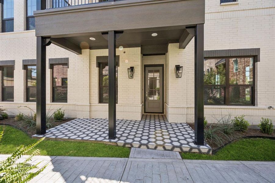 Large covered patio at front entrance with decorative tile. Large covered patio at front entrance with decorative tile.