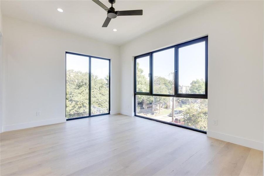 Spare room with ceiling fan and light wood-type flooring