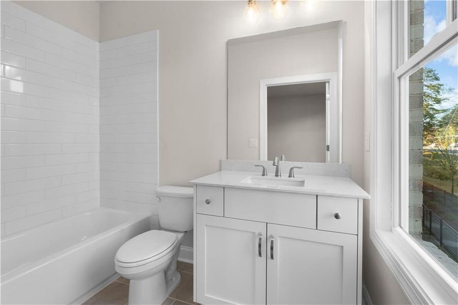 Bathroom featuring vanity and bathing tub / shower combination