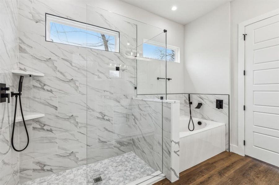 Bathroom featuring plus walk in shower and wood-type flooring