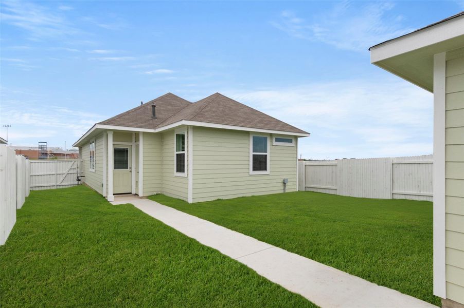 Back of house with roof with shingles and a fenced backyard Back of house with roof with shingles and a fenced backyard