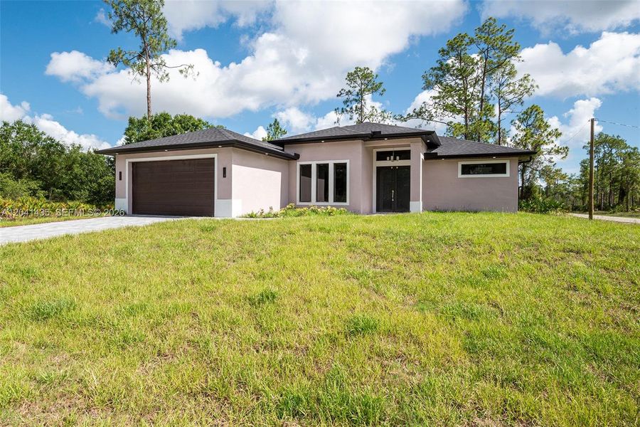 Front exterior of a new home in , Lehigh Acres, FL, highlighting curb appeal (Image 24).