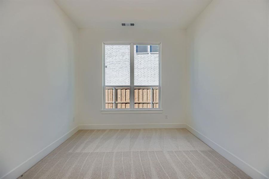 Spare room featuring light carpet and baseboards Spare room featuring light carpet and baseboards