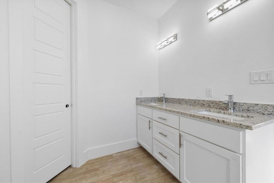 Bathroom featuring vanity and hardwood / wood-style flooring