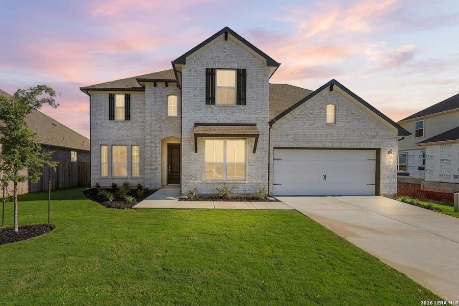 Front exterior of a new home in Megan's Landing, Castroville, TX, highlighting curb appeal (Image 21).