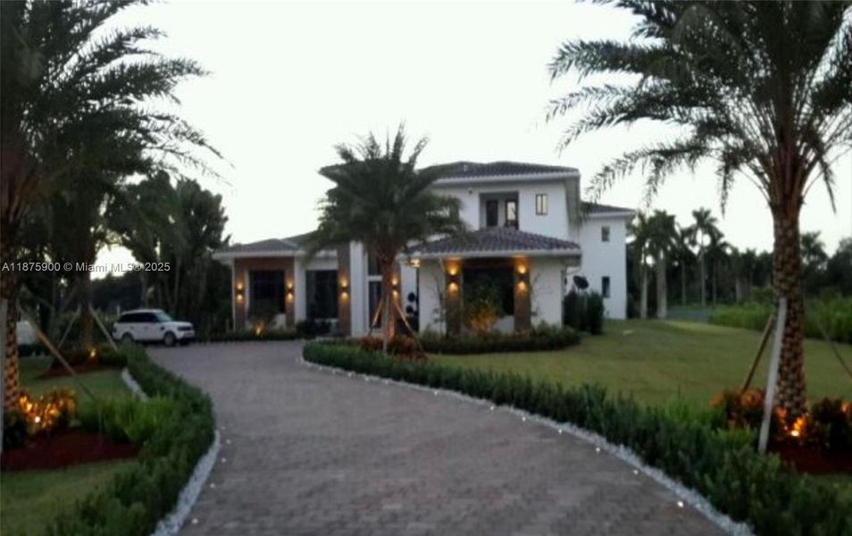 Front exterior of a new home in , Southwest Ranches, FL, highlighting curb appeal (Image 1).