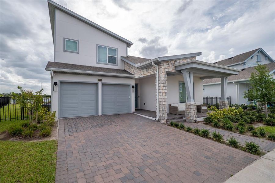 Front exterior of a new home in Laureate Park, Orlando, FL, highlighting curb appeal (Image 27). Front exterior of a new home in Laureate Park, Orlando, FL, highlighting curb appeal (Image 27).