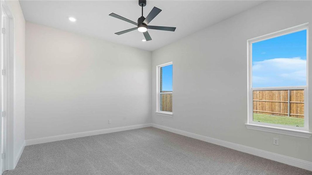Unfurnished room with light colored carpet, ceiling fan, and recessed lighting