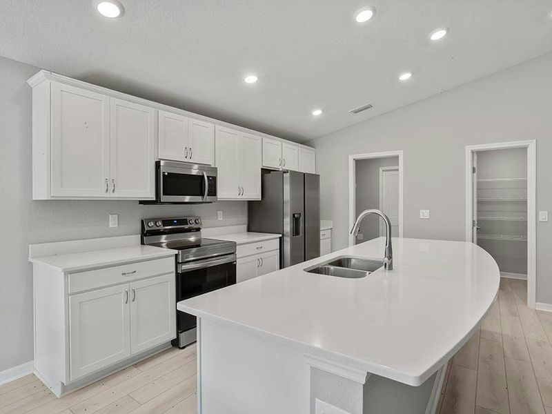Your bright, open kitchen includes quartz, 36-inch cabinets, Samsung SS appliances, and a walk-in pantry.