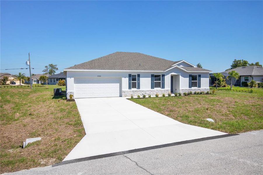 Front exterior of a new home in Burnt Store Village, Punta Gorda, FL, highlighting curb appeal (Image 20).