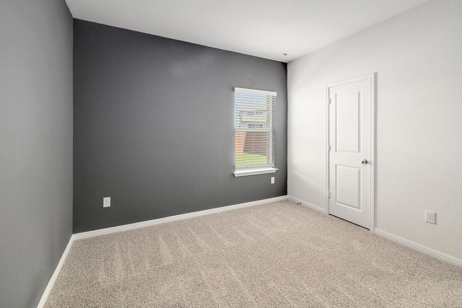 Room featuring a neutral carpeted floor, white baseboards, and a window with blinds Room featuring a neutral carpeted floor, white baseboards, and a window with blinds