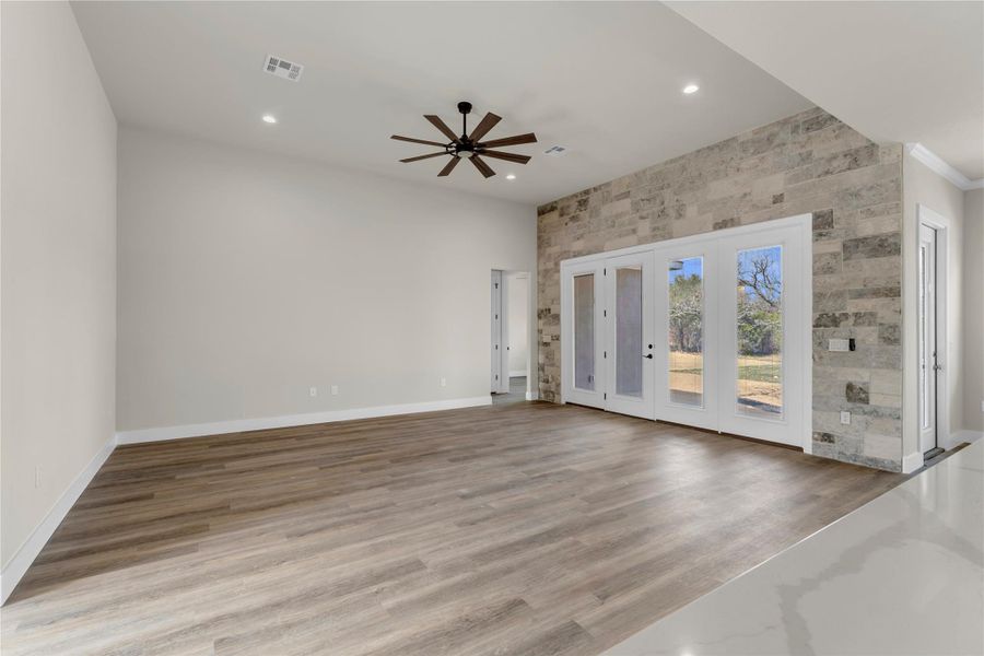 Spare room with ceiling fan, light wood-style flooring, and recessed lighting