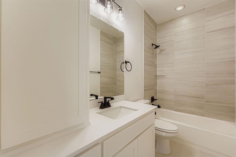 Bathroom with vanity, shower / bathtub combination, and recessed lighting Bathroom with vanity, shower / bathtub combination, and recessed lighting