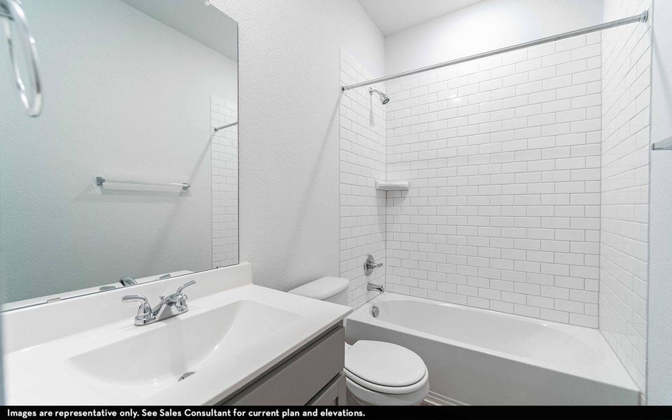 Bathroom featuring vanity, a textured wall, and shower / bathtub combination
