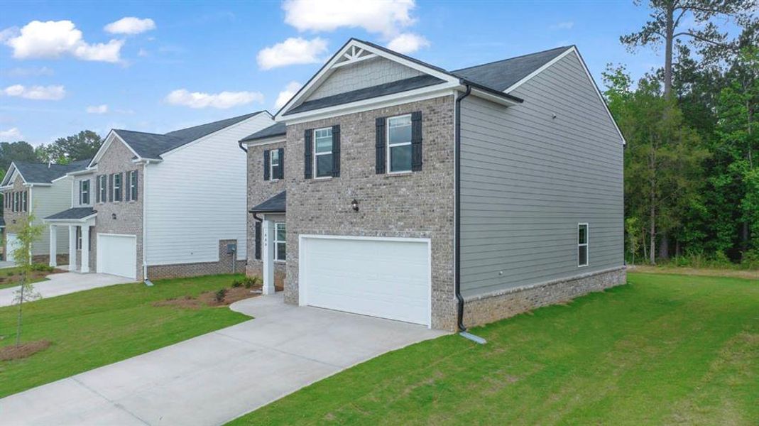 Front exterior of a new home in The Reserve at Calcutta, Stockbridge, GA, highlighting curb appeal (Image 22). Front exterior of a new home in The Reserve at Calcutta, Stockbridge, GA, highlighting curb appeal (Image 22).