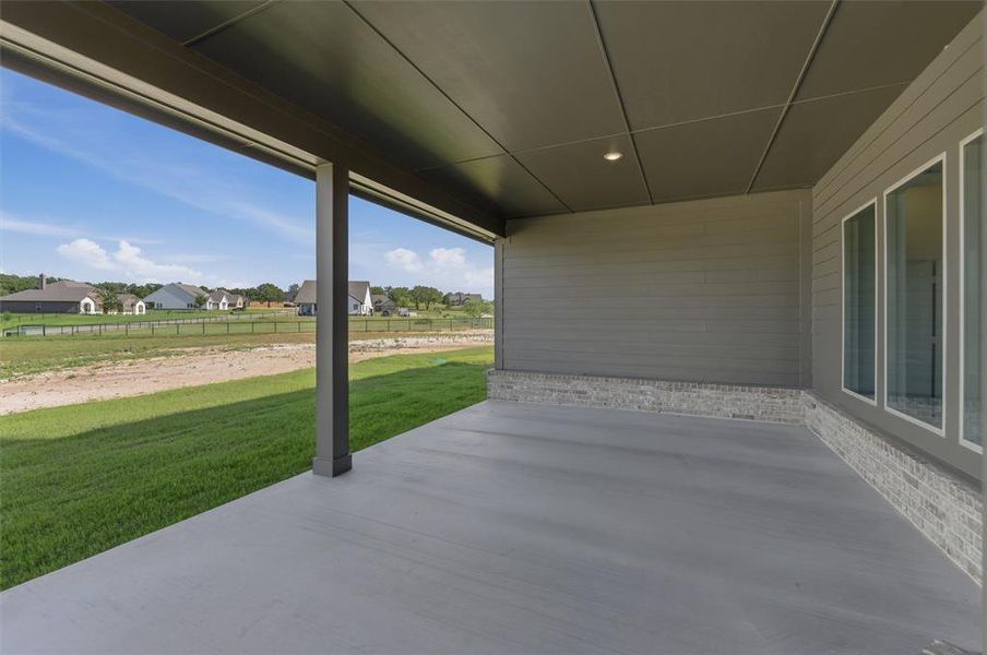 Expansive covered patio featuring a concrete surface and recessed lighting Expansive covered patio featuring a concrete surface and recessed lighting