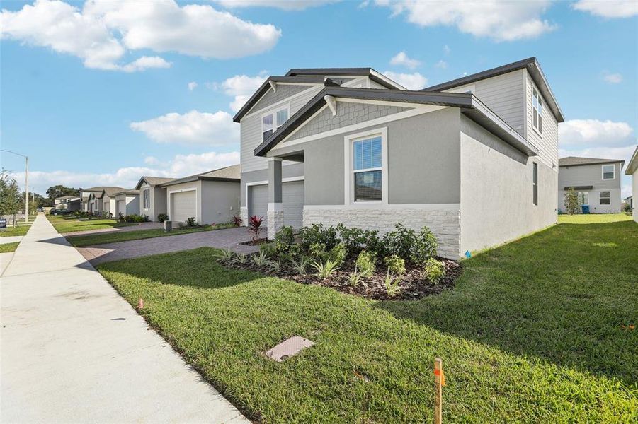 Front exterior of a new home in Lawson Dunes - Signature Series, Haines City, FL, highlighting curb appeal (Image 26).