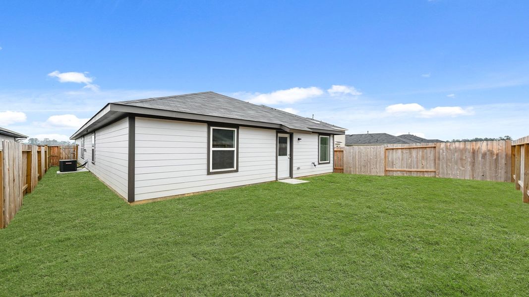 Exterior details and patio area of a home in The Canopies, Splendora (Image 17).