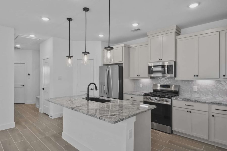 Representative furnished interior of a home built from the Carriagehouse by Chesmar Homes in Meridiana Townhomes, Iowa Colony (Image 6).