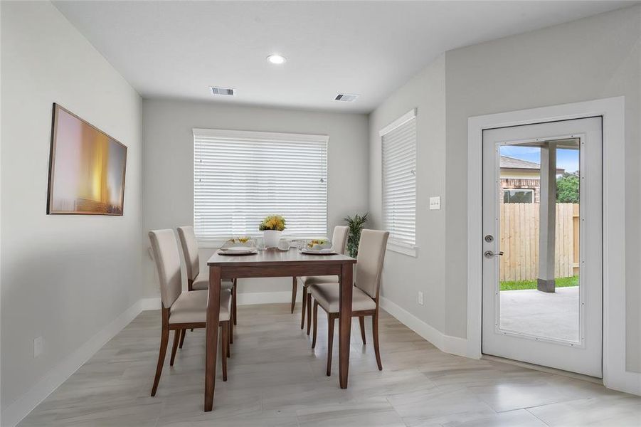 Start your day off right with a cup of coffee sitting with your family in the lovely breakfast area! Featuring large windows with blinds, custom neutral paint, tile flooring, recessed lighting and high ceilings.