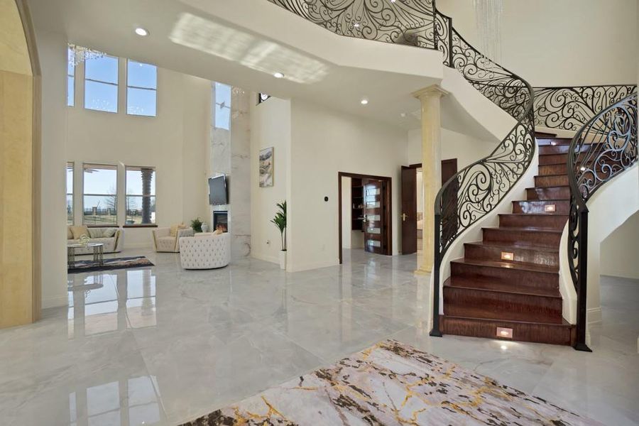 Entrance foyer featuring decorative columns and a high ceiling