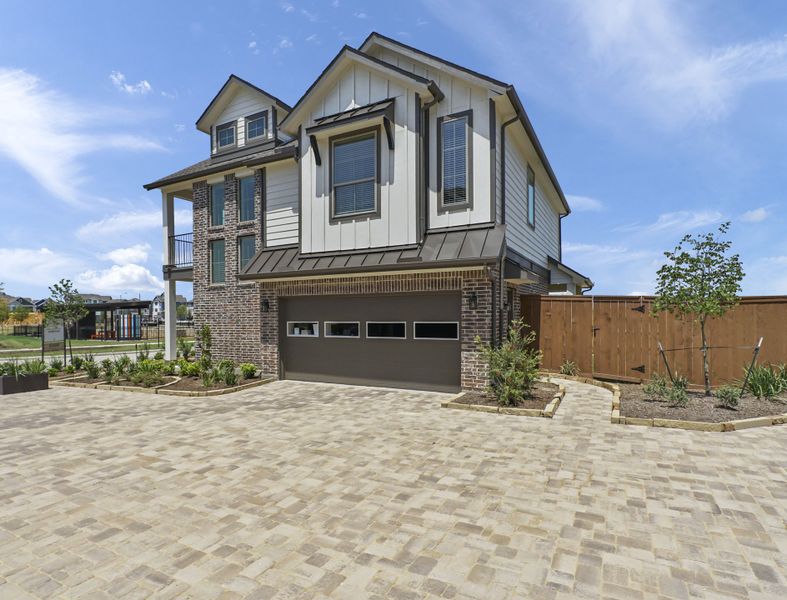 Front exterior of a new home in Elyson, Katy, TX, highlighting curb appeal (Image 21). Front exterior of a new home in Elyson, Katy, TX, highlighting curb appeal (Image 21).