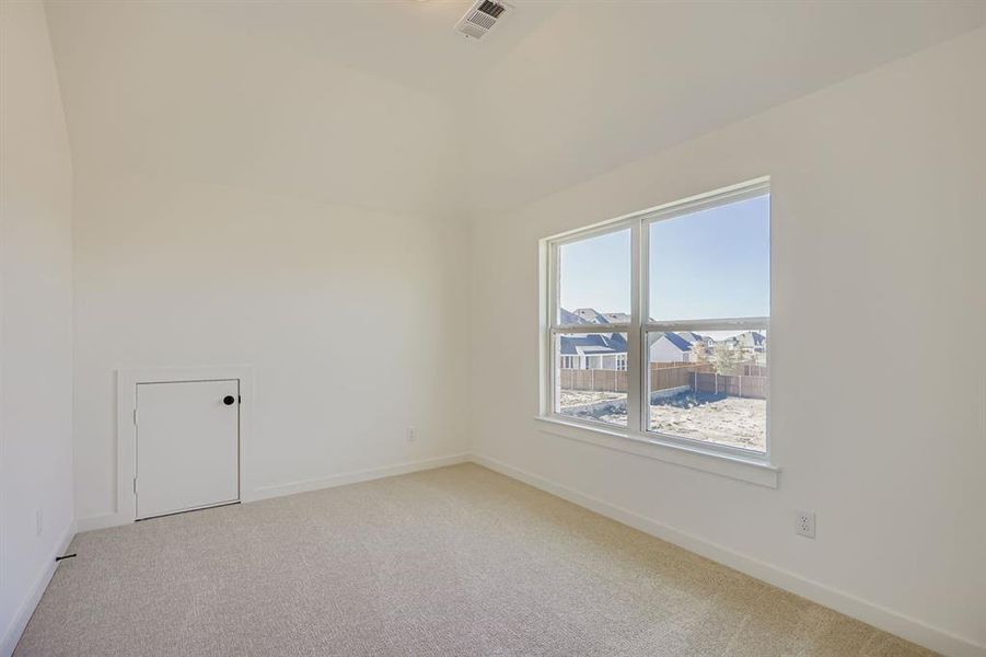 Spare room with light carpet and baseboards Spare room with light carpet and baseboards