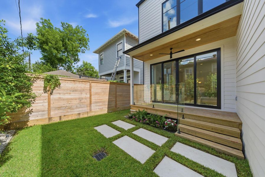 Private fenced backyard with covered patio and green space. Private fenced backyard with covered patio and green space.