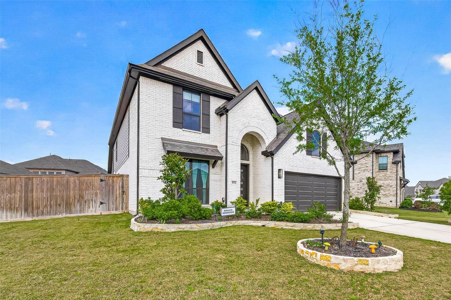 Front exterior of a new home in Candela, Richmond, TX, highlighting curb appeal (Image 2).