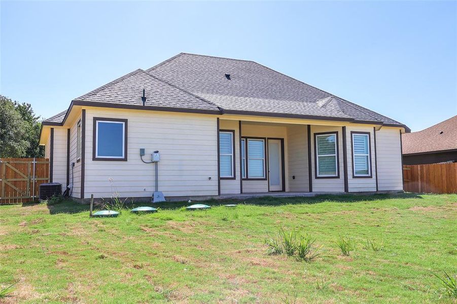 Back of property with a shingled roof Back of property with a shingled roof