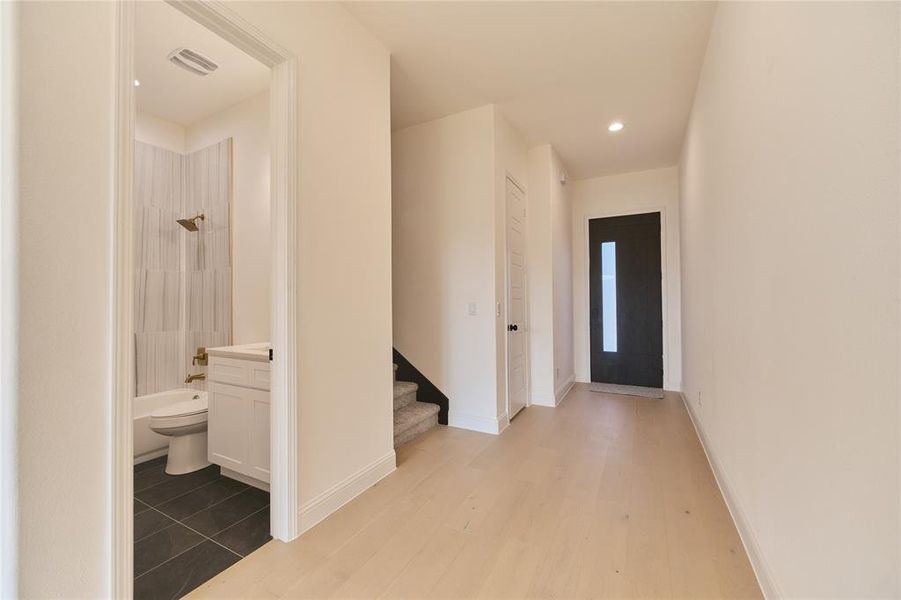 Entrance foyer with light hardwood / wood-style flooring