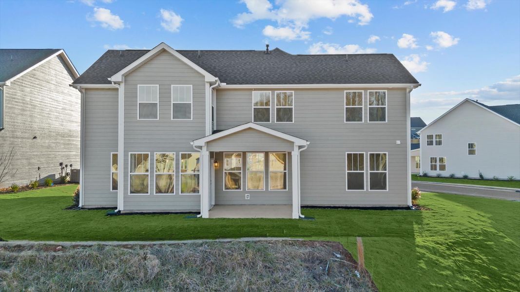 Rear covered porch creates a seamless extension of this home’s elegant design