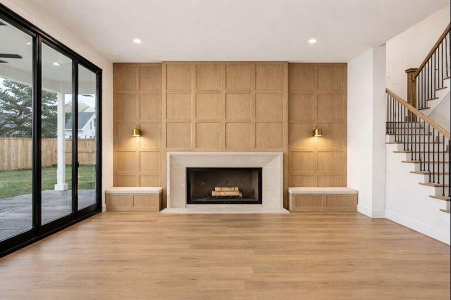 Spacious Living Room features large sliding glass door, ample windows, fireplace with stone surround, custom trim detail   *this photo has been virtually rendered based on a previously constructed home by the builder. 1248 Chamboard may have different selections at builders sole discretion. These photos are not meant to be an exact representation of 1248 Chamboard.