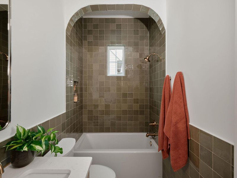 Bathroom with tile walls, wainscoting, shower / tub combination, and vanity Bathroom with tile walls, wainscoting, shower / tub combination, and vanity