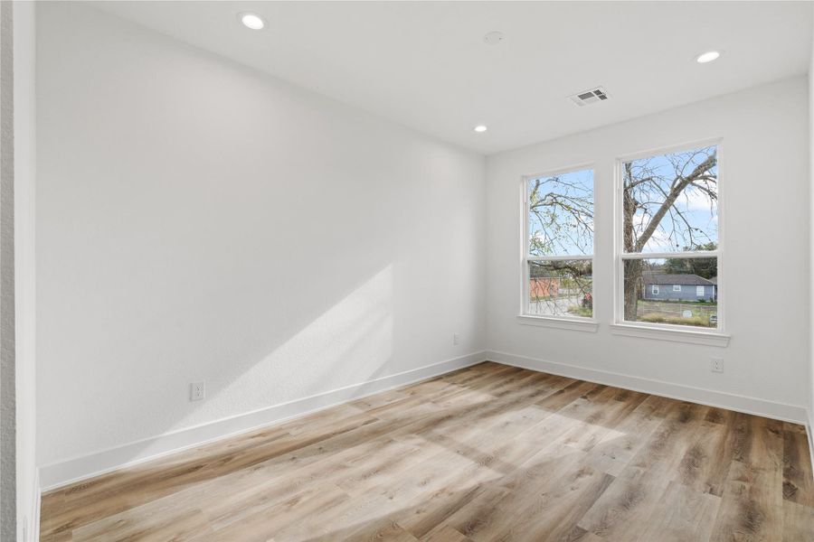 Spacious secondary bedroom with large windows and great natural light.
