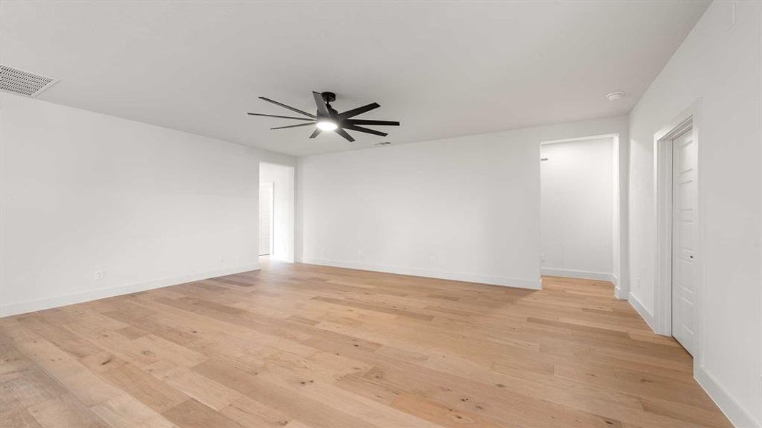 Spare room with ceiling fan and light wood-type flooring