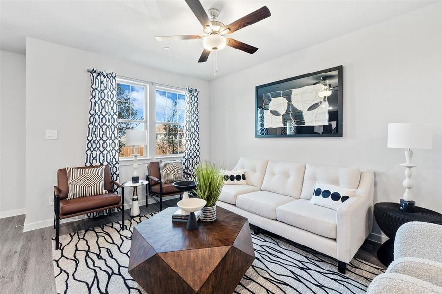 Living room featuring ceiling fan and light hardwood / wood-style floors