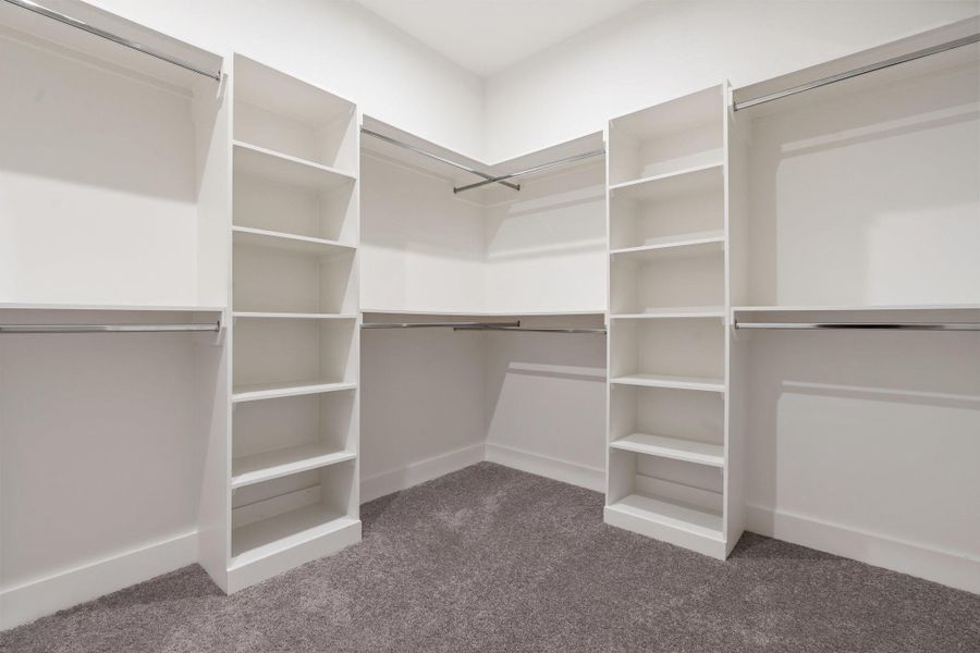 Spacious primary closet includes a bonus storage room, offering even more space for organization and convenience. Spacious primary closet includes a bonus storage room, offering even more space for organization and convenience.