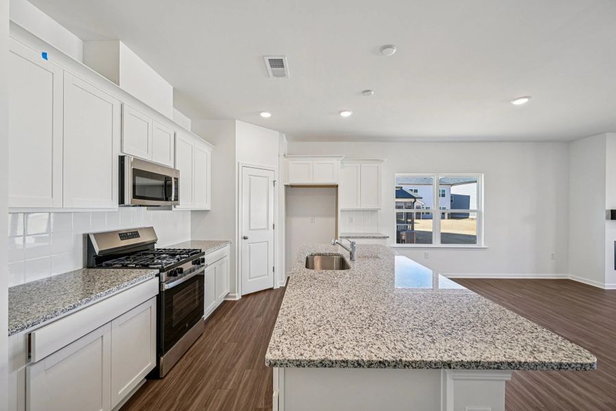 Kitchen - Chic white finishes and smooth surfaces shine.