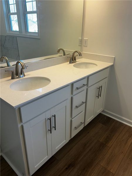 This primary bathroom features a dual vanity, prov
