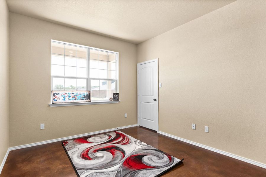 Unfurnished room with finished concrete flooring and baseboards