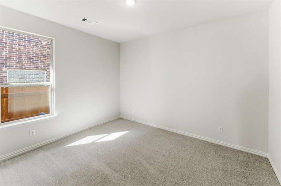 Spare room with baseboards and carpet