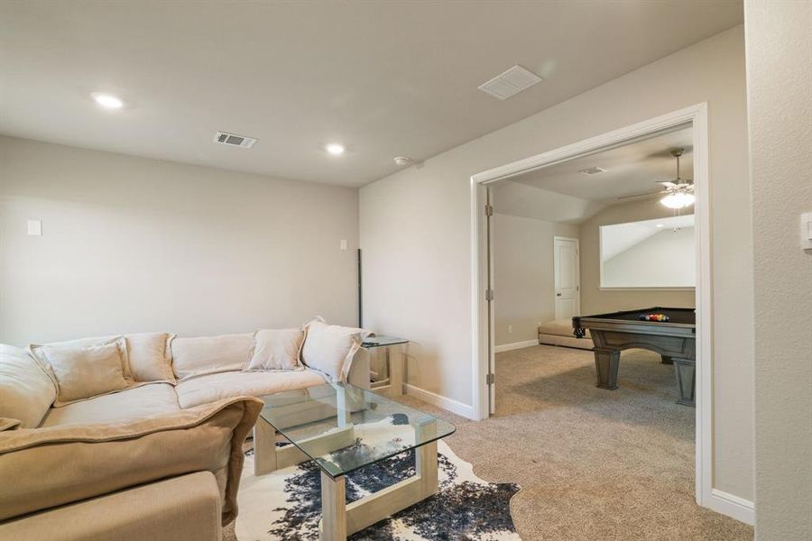 Living room featuring light colored carpet, ceiling fan, recessed lighting, and billiards Living room featuring light colored carpet, ceiling fan, recessed lighting, and billiards