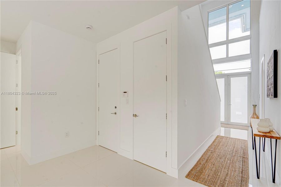 To your left you can see a door to a storage area, door to garage and door to the guest bathroom. To your left you can see a door to a storage area, door to garage and door to the guest bathroom.