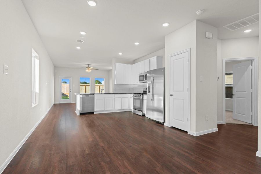 Beautiful view from the dining area looking into the gourmet kitchen, highlighting modern finishes, stainless steel appliances, and stylish lighting—all designed for comfort and convenience. All appliances included! Down the hallway to your right you will discover the two guest bedrooms tucked away from the primary suite. Beautiful view from the dining area looking into the gourmet kitchen, highlighting modern finishes, stainless steel appliances, and stylish lighting—all designed for comfort and convenience. All appliances included! Down the hallway to your right you will discover the two guest bedrooms tucked away from the primary suite.