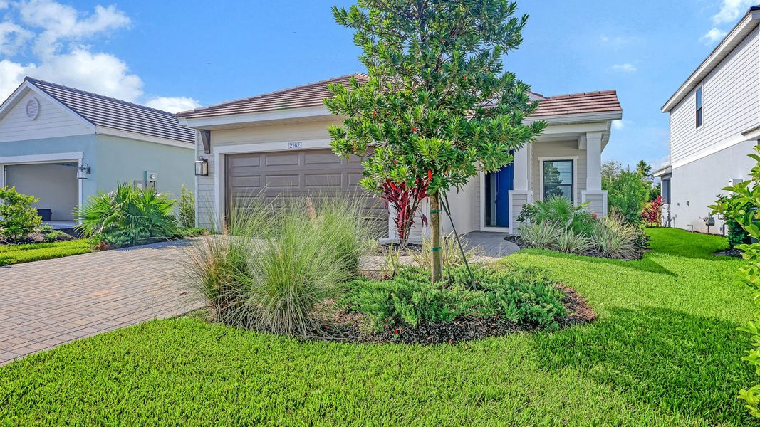 Front exterior of a new home in Palm Grove Real Estate and Homes for Sale in Lakewood Ranch, FL - Neal Communities, Lakewood Ranch, FL, highlighting curb appeal (Image 1). Front exterior of a new home in Palm Grove Real Estate and Homes for Sale in Lakewood Ranch, FL - Neal Communities, Lakewood Ranch, FL, highlighting curb appeal (Image 1).