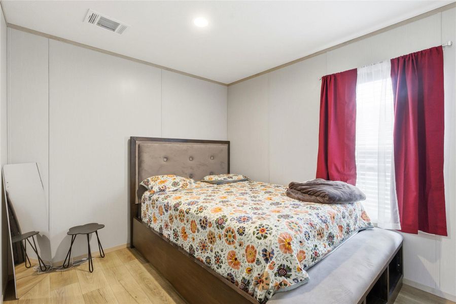Well-lit sleeping quarters with paneled walls and warm wood flooring provide a restful retreat.