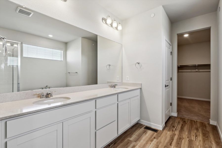 A bathroom with a large mirror.